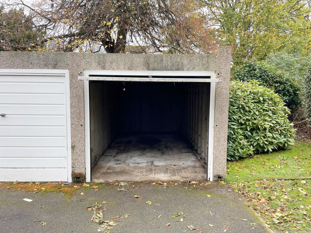Lot: 32 - FLAT WITH GARAGE AND GARDEN IN NEED OF UPDATING - Garage with open door
